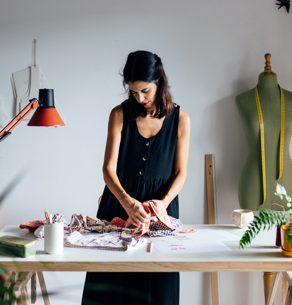 An entrepreneur fashion designer working in her studio